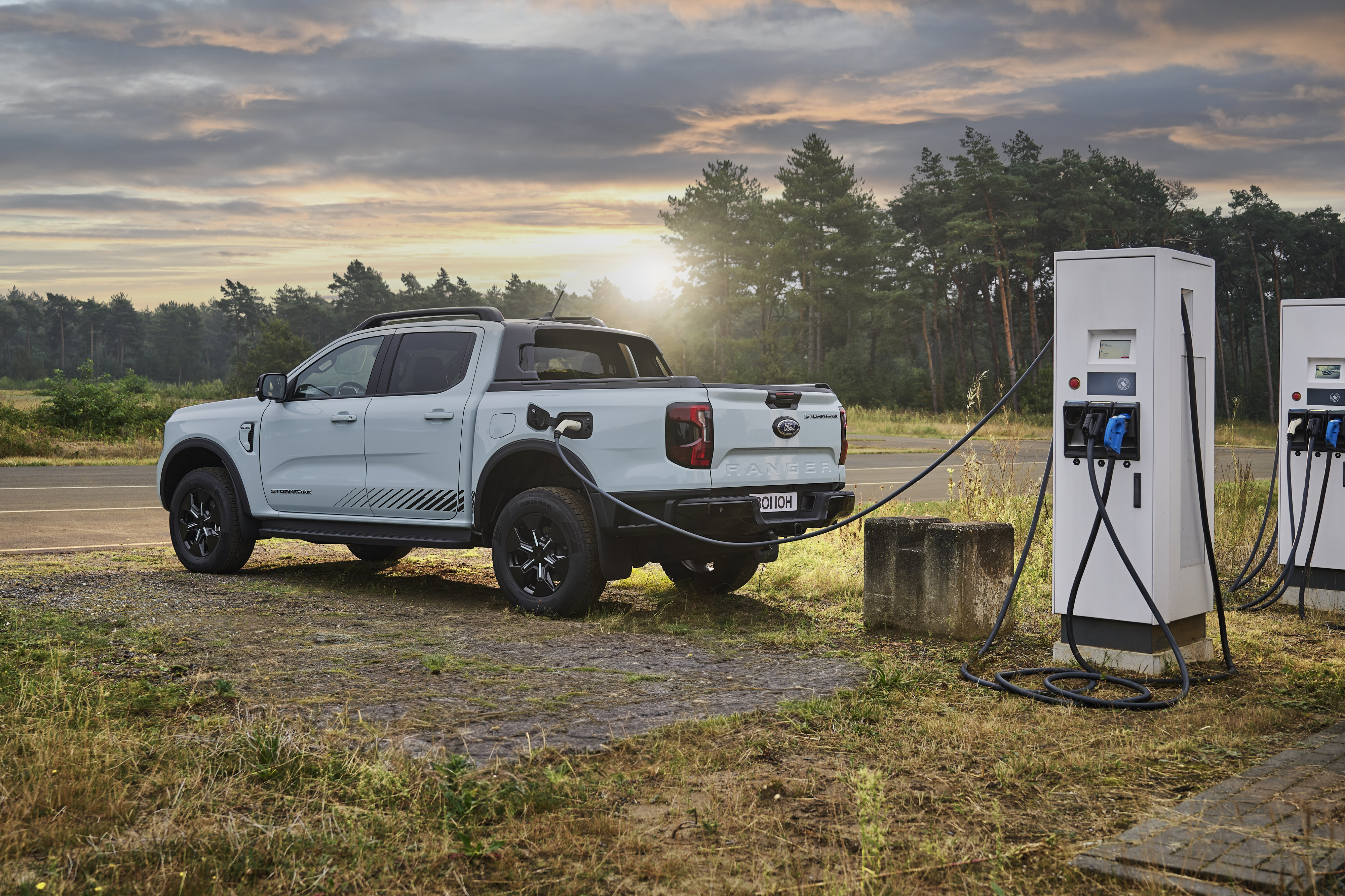 a white pickup charging at sunset 